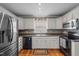 Functional kitchen with stainless steel appliances and white cabinetry at 323 E Stratford Dr, Henderson, NC 27537