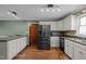 Well-equipped kitchen with stainless steel refrigerator and ample storage space at 323 E Stratford Dr, Henderson, NC 27537