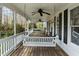 Spacious covered front porch with a swing and rocking chairs at 323 E Stratford Dr, Henderson, NC 27537