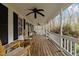 Inviting porch with rocking chairs and a ceiling fan overlooking the yard at 323 E Stratford Dr, Henderson, NC 27537