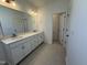 Bathroom featuring double vanity sinks, modern cabinetry, and a large mirror for getting ready in the morning at 37 Furley St., Homesite 38, Sanford, NC 27330