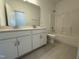 Bright bathroom featuring double vanity sinks and updated tile floors at 37 Furley St., Homesite 38, Sanford, NC 27330