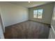 Well-lit bedroom featuring neutral walls, plush carpeting, and a window offering plenty of natural light at 37 Furley St., Homesite 38, Sanford, NC 27330