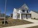 Charming two-story home with a two-car garage, flag, and a well-maintained lawn in a suburban neighborhood at 37 Furley St., Homesite 38, Sanford, NC 27330
