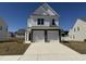 Beautiful two-story home with a two-car garage, brick accents, and a well-manicured lawn on a sunny day at 37 Furley St., Homesite 38, Sanford, NC 27330