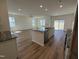 Modern open-concept kitchen featuring an island with seating, stainless steel appliances, and granite countertops at 37 Furley St., Homesite 38, Sanford, NC 27330