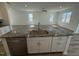 The gourmet kitchen features an island with granite counters, stainless steel dishwasher, and white cabinets at 37 Furley St., Homesite 38, Sanford, NC 27330