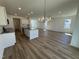 Spacious open kitchen with a large island, stainless steel appliances, granite countertops, and white cabinetry at 37 Furley St., Homesite 38, Sanford, NC 27330