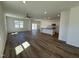 Open-concept living space with wood-look floors, bright windows, a ceiling fan, and a kitchen featuring a central island at 37 Furley St., Homesite 38, Sanford, NC 27330