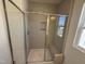 Newly installed shower features built-in shelving, a bench, and bright lighting to create the perfect wash space at 37 Furley St., Homesite 38, Sanford, NC 27330