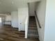 Staircase with carpeted steps and wooden railing, leading to the upper level of the home at 37 Furley St., Homesite 38, Sanford, NC 27330