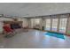 Spacious basement with painted floors, brick fireplace, and french doors to the exterior at 382 Wimbledon Dr, Roxboro, NC 27573