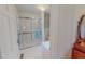 Bright bathroom featuring glass-enclosed shower with white tile surround at 382 Wimbledon Dr, Roxboro, NC 27573