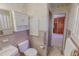 Bathroom features classic pink tiling, white cabinets, and access to a shower room at 382 Wimbledon Dr, Roxboro, NC 27573
