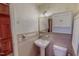 Cozy bathroom with pink tiling, pedestal sink, and classic white fixtures at 382 Wimbledon Dr, Roxboro, NC 27573