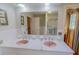 Well-lit bathroom boasting a double sink vanity and shower with glass door at 382 Wimbledon Dr, Roxboro, NC 27573