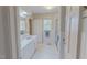 Spacious bathroom featuring white tile, a glass shower, and a marble top vanity at 382 Wimbledon Dr, Roxboro, NC 27573