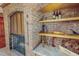 Brick fireplace with shelves and cooking utensils for decorative purposes at 382 Wimbledon Dr, Roxboro, NC 27573