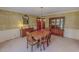 Formal dining room featuring wallpaper, wood table with chairs, and built-in china cabinet at 382 Wimbledon Dr, Roxboro, NC 27573