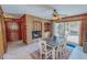 Charming dining area with a brick fireplace, a wooden table, and sliding doors to an outdoor patio at 382 Wimbledon Dr, Roxboro, NC 27573