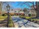 Elegant brick home with a well-maintained lawn and a long driveway lined with manicured shrubs at 382 Wimbledon Dr, Roxboro, NC 27573