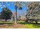 Scenic view of a brick home nestled among mature trees, offering privacy and a serene setting at 382 Wimbledon Dr, Roxboro, NC 27573
