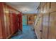 Grand foyer with wood paneling, tile flooring, and a decorative mirror reflecting natural light at 382 Wimbledon Dr, Roxboro, NC 27573