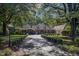 Charming brick home featuring mature trees and a manicured lawn with a long private driveway at 382 Wimbledon Dr, Roxboro, NC 27573