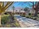 Charming brick home with a circular driveway, mature trees, and manicured landscaping at 382 Wimbledon Dr, Roxboro, NC 27573