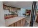 Basement kitchen includes a wooden island, cabinetry, sink, and a white refrigerator at 382 Wimbledon Dr, Roxboro, NC 27573