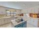 Bright kitchen with white cabinets, stainless steel appliances, a blue island, and ample counter space at 382 Wimbledon Dr, Roxboro, NC 27573