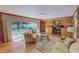 Inviting living room featuring hardwood floors, a cozy seating arrangement, and a view of the backyard at 382 Wimbledon Dr, Roxboro, NC 27573