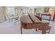Bright living area with a grand piano, beautiful windows, and access to the dining room at 382 Wimbledon Dr, Roxboro, NC 27573