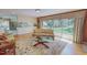 Comfortable living room with hardwood floors, a plush sofa, and sliding glass doors to the backyard at 382 Wimbledon Dr, Roxboro, NC 27573