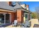 Outdoor patio with table and chairs with a beautiful view of trees at 382 Wimbledon Dr, Roxboro, NC 27573