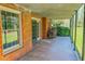 Covered patio features classic brickwork, a tiled floor, a cozy seating area, and ample space for relaxation at 382 Wimbledon Dr, Roxboro, NC 27573
