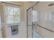 Shower with glass door and accessible hand rails in a bright bathroom at 382 Wimbledon Dr, Roxboro, NC 27573
