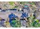Birds-eye view showing the townhome roofs, decks, surrounding trees and landscape, with privacy at 3923 Wendy Ln, Raleigh, NC 27606