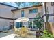 Backyard view of a wooden deck, chairs, table with umbrella, and trees at 3923 Wendy Ln, Raleigh, NC 27606