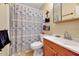 Functional bathroom features a shower with patterned curtain and ample vanity storage at 3923 Wendy Ln, Raleigh, NC 27606