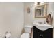 Cozy bathroom with a modern vanity, decorative mirror, and neutral wall color at 3923 Wendy Ln, Raleigh, NC 27606