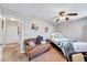 Comfortable bedroom featuring a ceiling fan, cozy bed, and a seating area at 3923 Wendy Ln, Raleigh, NC 27606