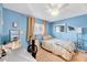 Cozy bedroom with light blue walls, ceiling fan, desk and shelving at 3923 Wendy Ln, Raleigh, NC 27606