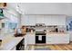 Bright kitchen with white cabinets, butcher block countertops, and stainless steel appliances at 3923 Wendy Ln, Raleigh, NC 27606