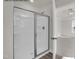 Modern bathroom featuring a glass shower with a white shower base and tile surround at 4012 Kingcraig Ln, Zebulon, NC 27597