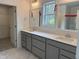 Bathroom featuring a dual vanity with mirrors, modern fixtures, and a window with natural light at 4012 Kingcraig Ln, Zebulon, NC 27597