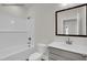 Bathroom featuring a bathtub, toilet, vanity with sink, mirror, and tiled walls at 4012 Kingcraig Ln, Zebulon, NC 27597