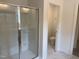 Bathroom with a glass-enclosed shower featuring built-in shelves, and a doorway leading to the toilet at 4012 Kingcraig Ln, Zebulon, NC 27597