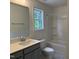 Bathroom featuring gray vanity, shower with tub, and bright natural light at 4012 Kingcraig Ln, Zebulon, NC 27597