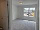 Bedroom with neutral carpeting and a window showcasing the outside neighborhood at 4012 Kingcraig Ln, Zebulon, NC 27597